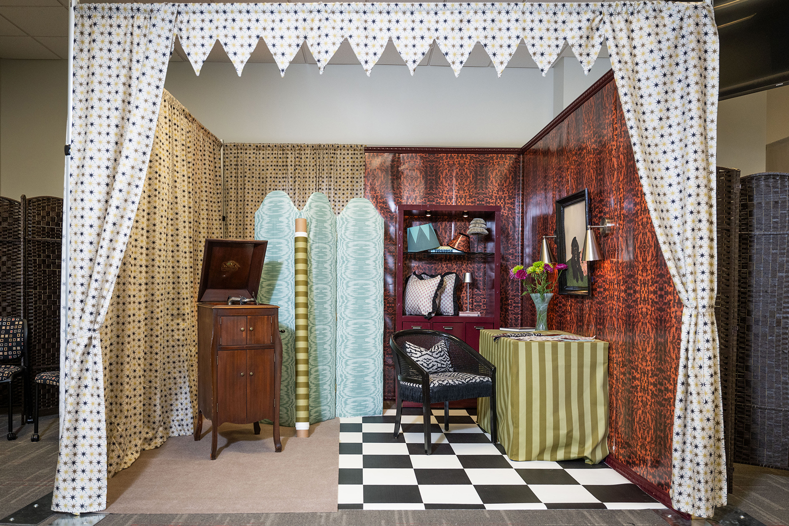 Photo of a room with a canopy, black and white checkerboard floor, bookshelf and other textiles.