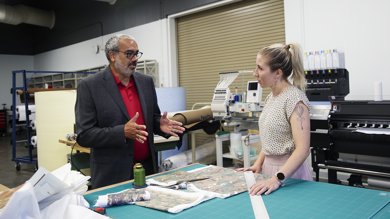 Andre West and Amanda Mills chat in a laboratory