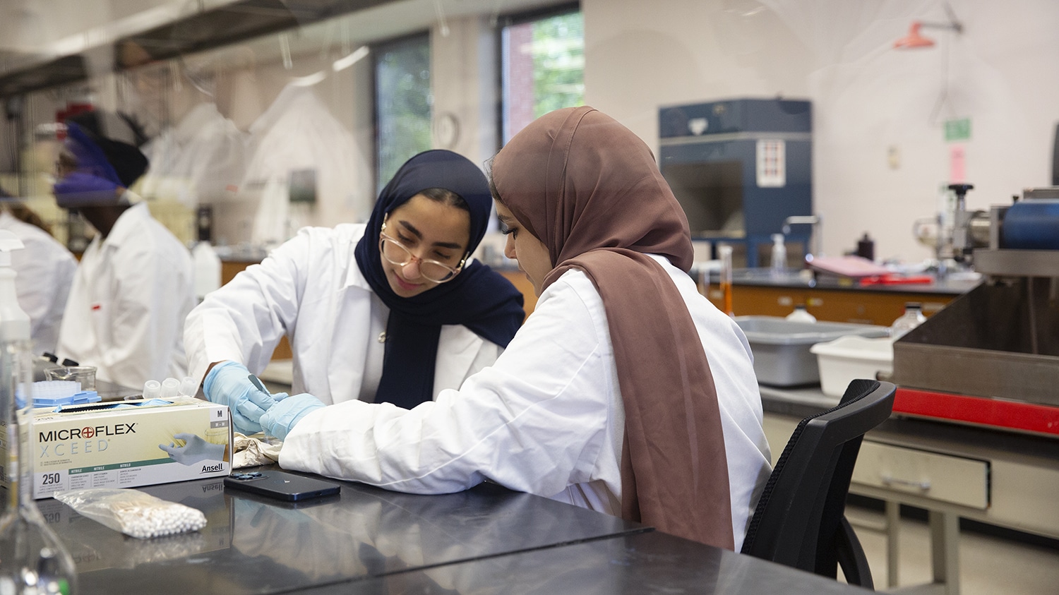 Two students work in a lab together.