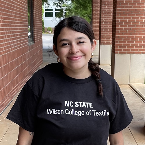 Photo of a woman in a black t-shirt.