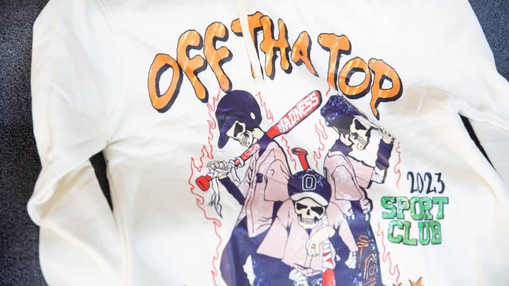 A sweatshirt with skeletons and the words "Off Tha Top" printed on it.