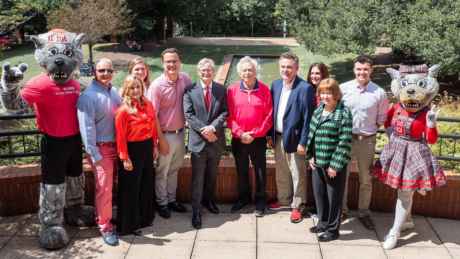 Wilson family smiling alongside Mr. and Ms. Wuf