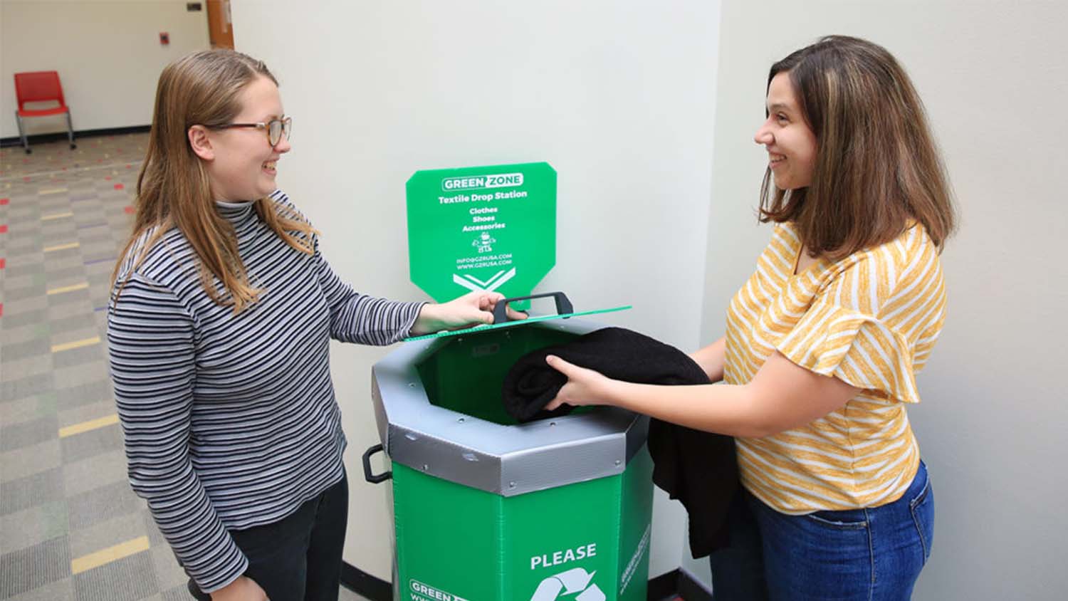 Students recycling at green zone bins