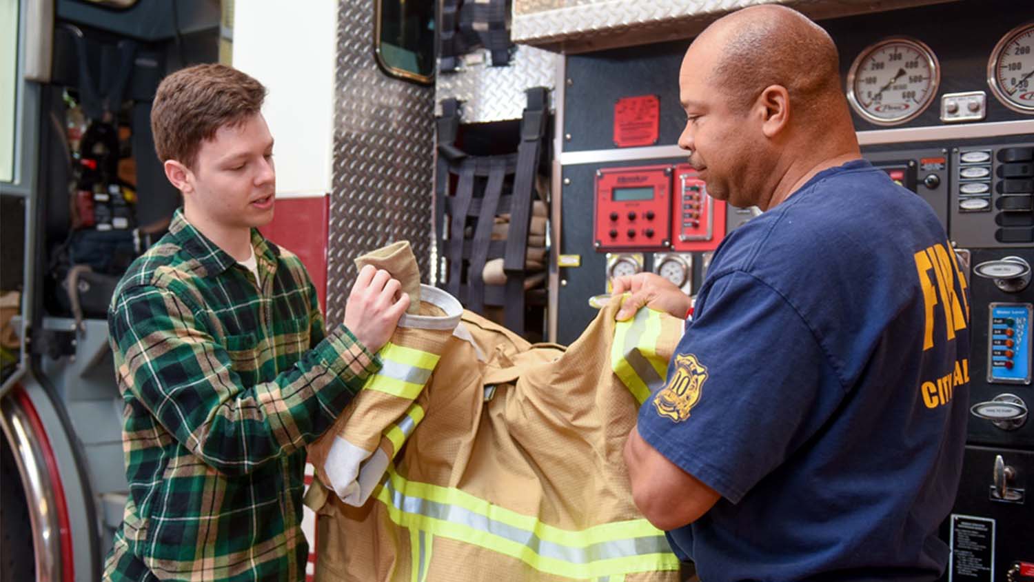 Chandler Maness with Raleigh firefighter Corey McGee