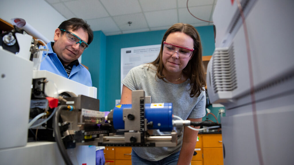 Undergraduate polymer and color chemistry student conducting research in a lab 