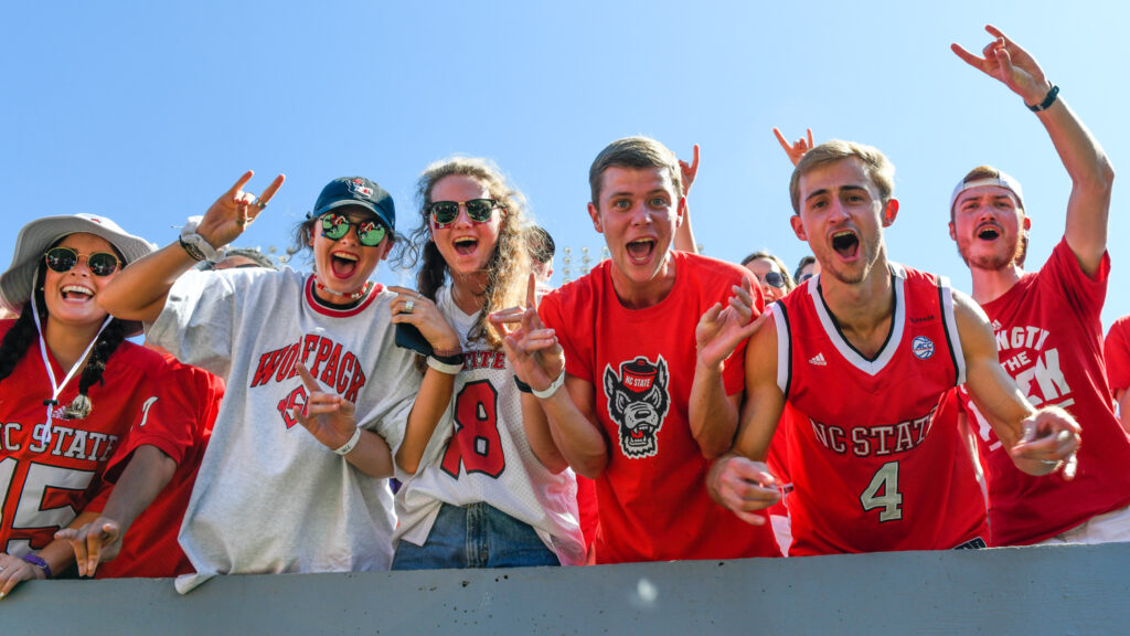 Students cheering during an NC State versus ECU football game at Carter Finely stadium