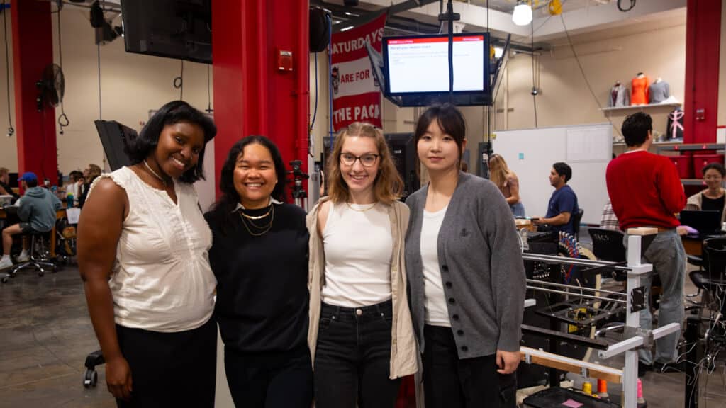 Team members pose together in studio.