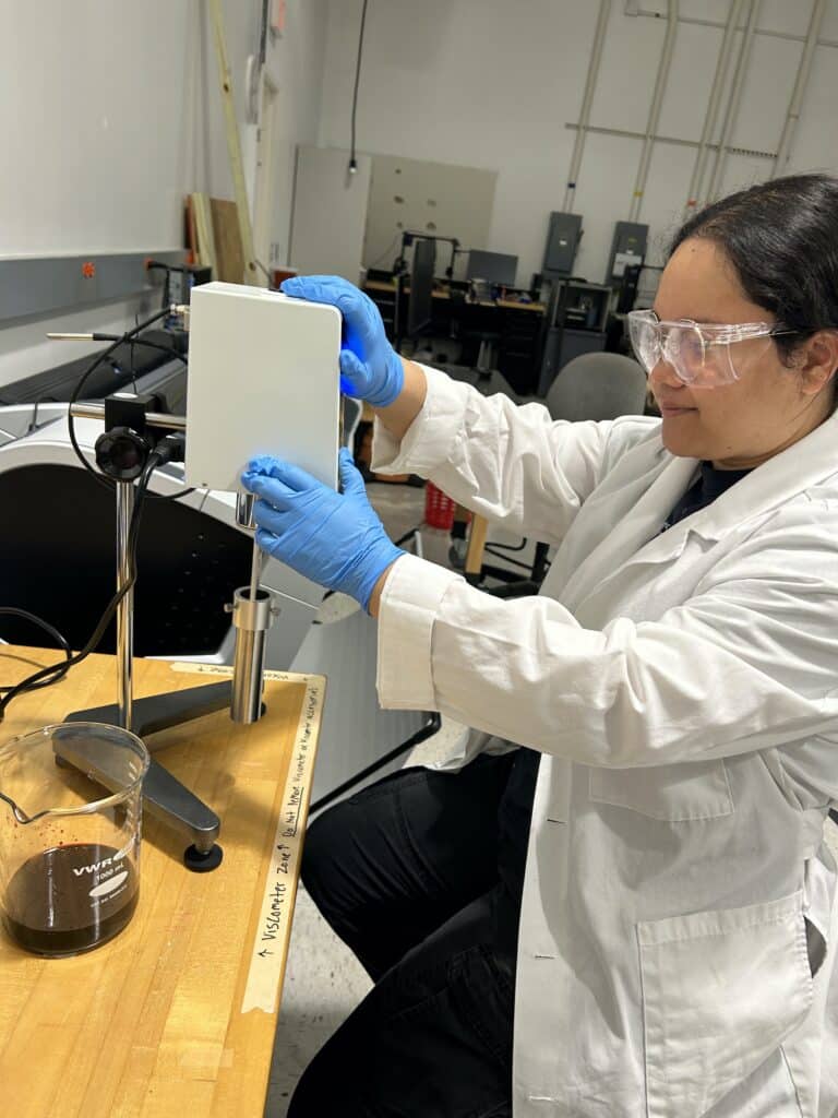 Team member uses lab equipment to create simulated blood. 