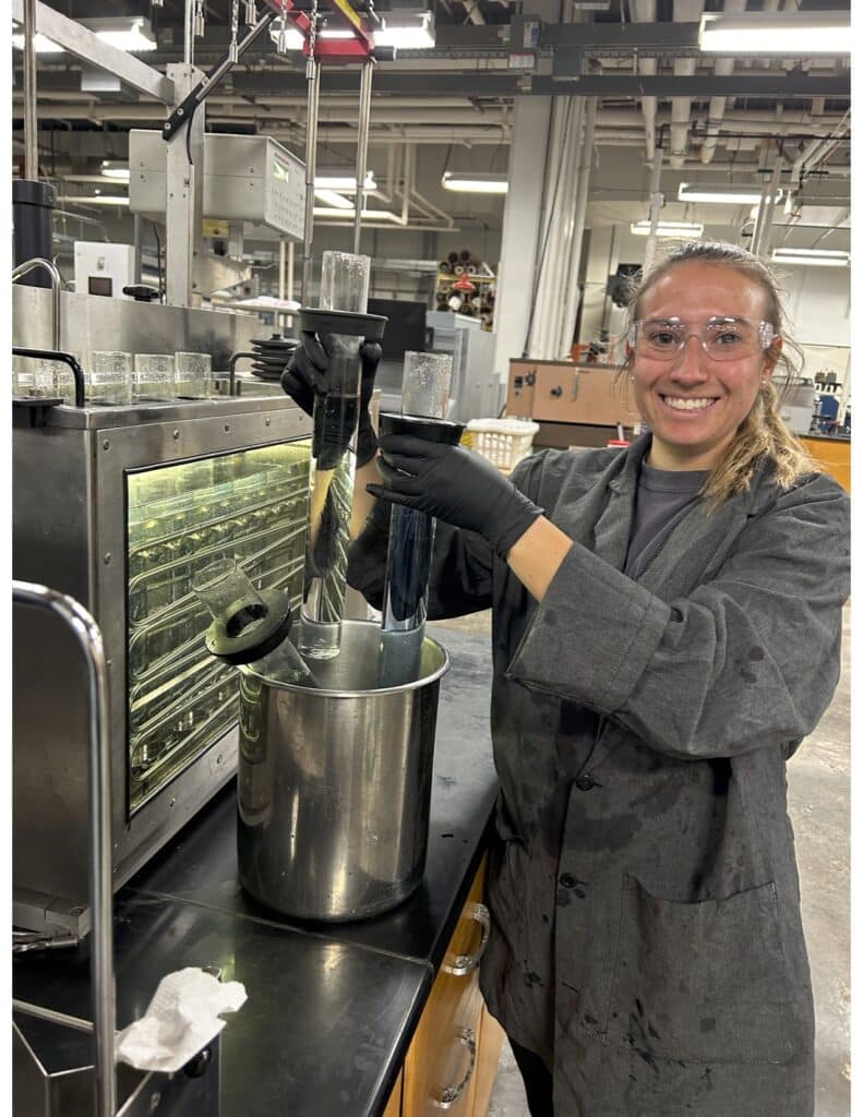 Team member stands at a workstation in the lab.  