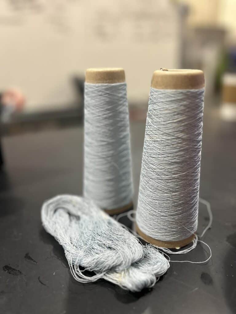 Two skeins of thread presented on table. 