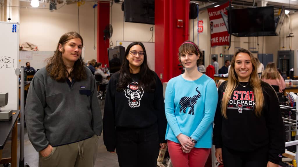 Team members stand together in the studio. 