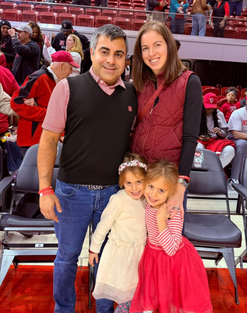 Zain Khan standing with his wife, Sarah, and their two children, Nora and Sophie.