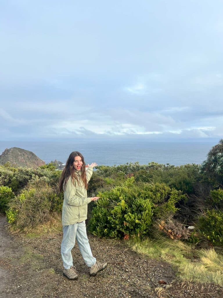 Kat Charrier pointing to the ocean
