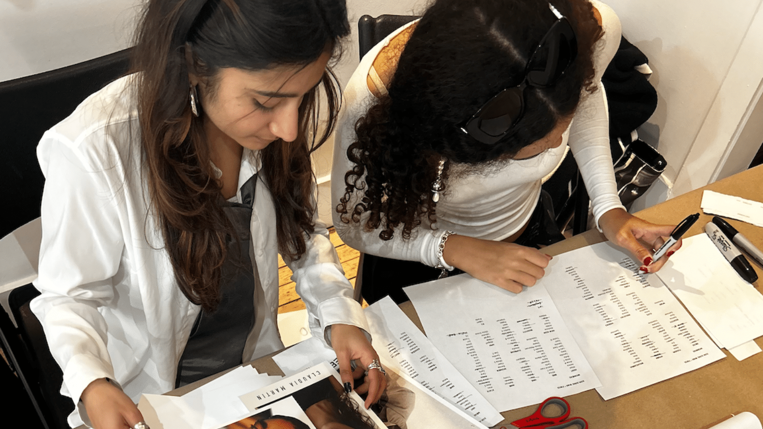 Two students working over a model call sheet.