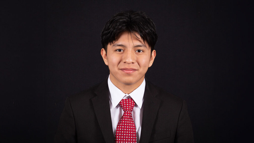 A student, Mike Menchu-Yax, smiling at the camera.