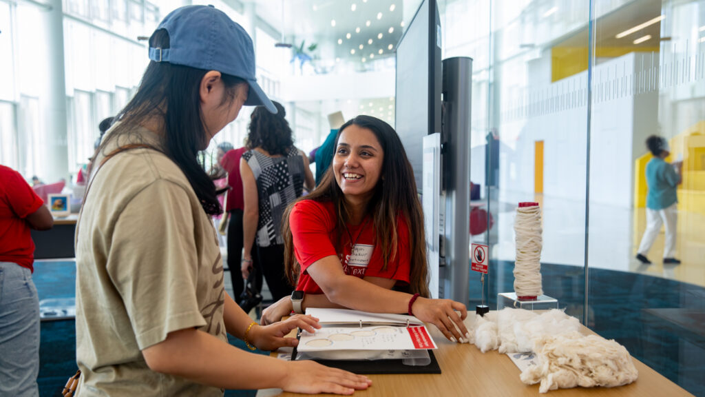 Mayuri Thakur points out the texture of the hemp blend on her presentation table at Hunt Library.