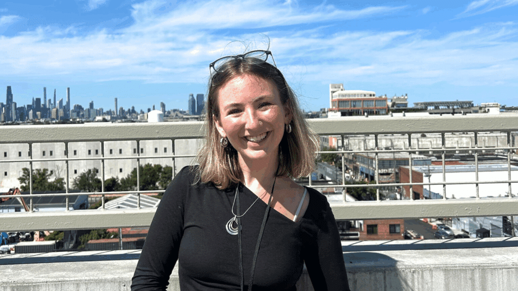 Katherine Damore poses on a rooftop overlooking New York City.