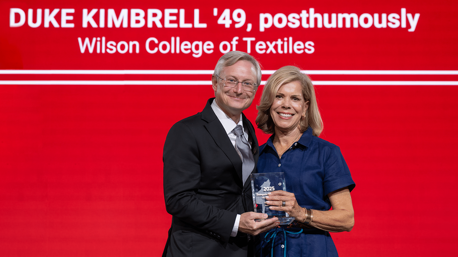 David Hinks and Pamela Warlick stand next to one another, while smiling.