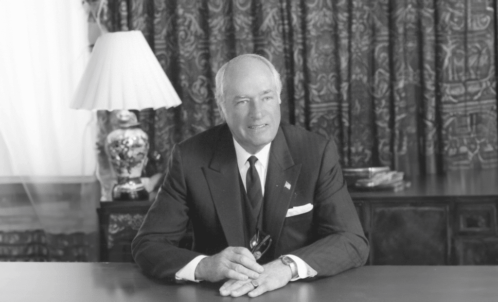 W. Duke Kimbrell smiling at the camera while sitting at his desk.