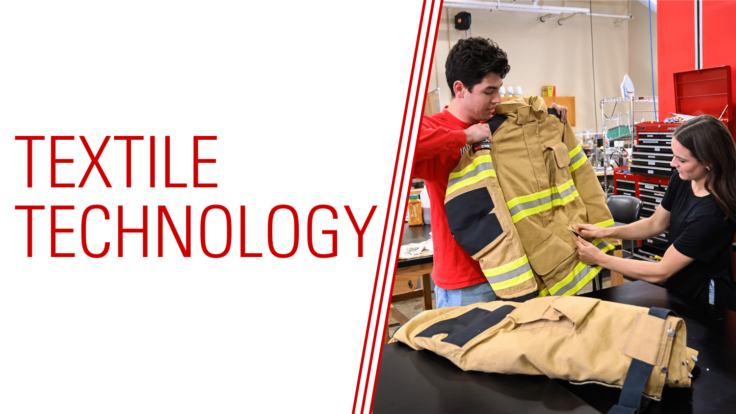 One student holds up a firefighter jacket while another examines its reflective stripes in a lab setting, with 
