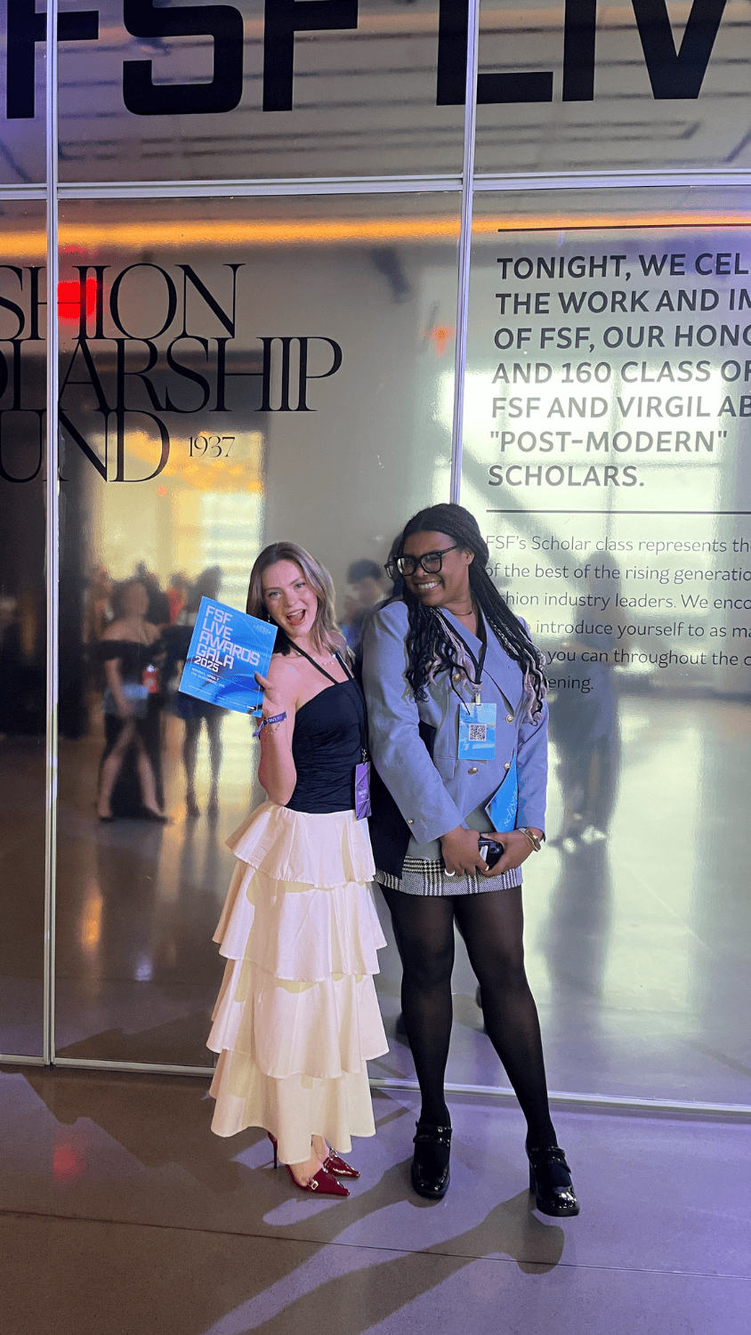 Rachel Kelly and Celia Fennell Stand smiling in front of a large FSF Scholarship Fund mirror display in formal wear.