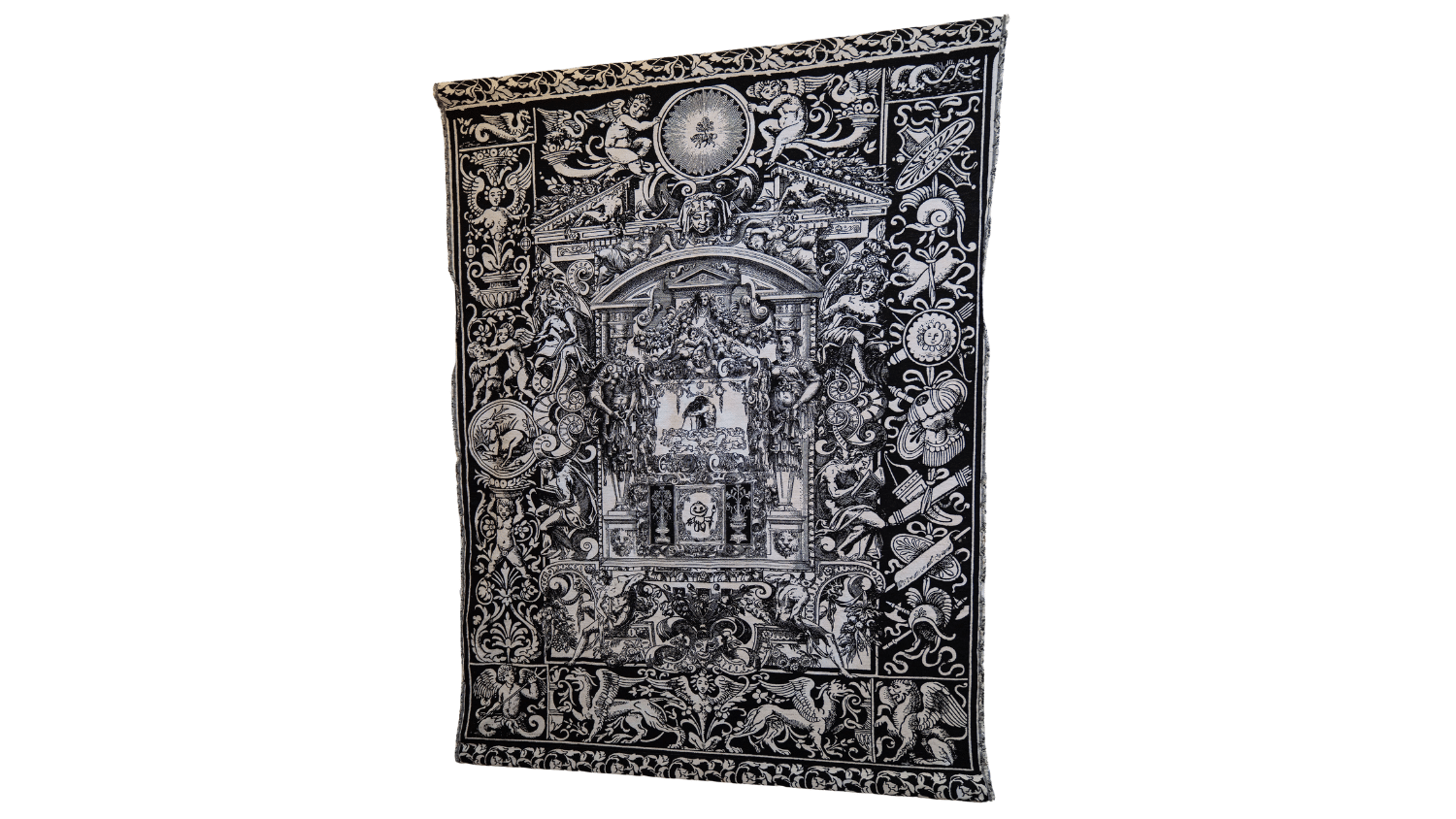 A tapestry created by Matthew Riddle shows images of angles, griffons, armor, weaponry and more woven in white on a black background.