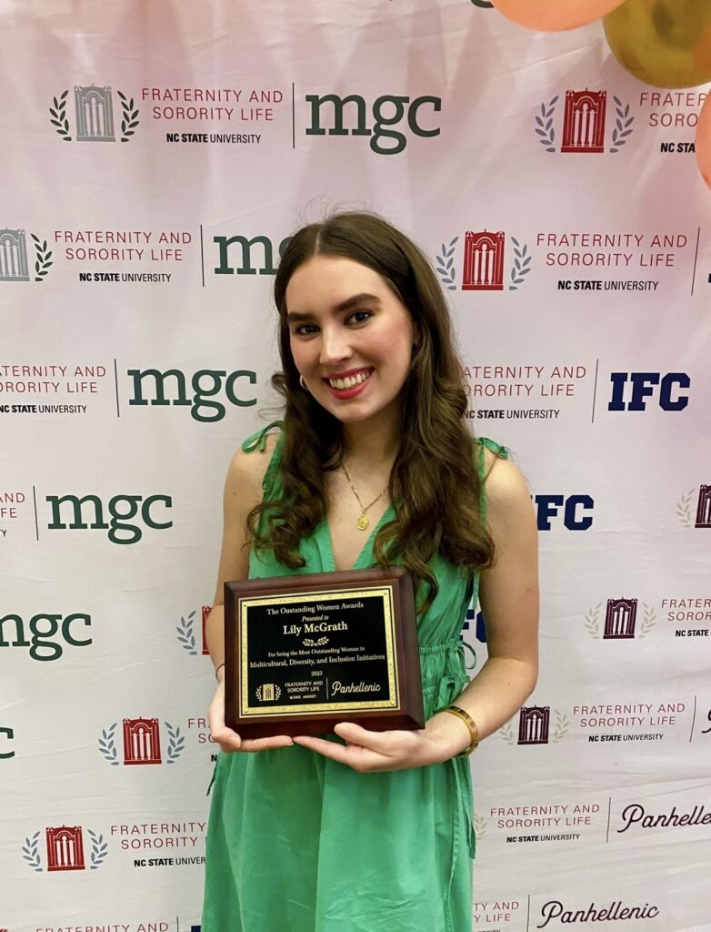 Image of Lily McGrath smiling while holding an award.