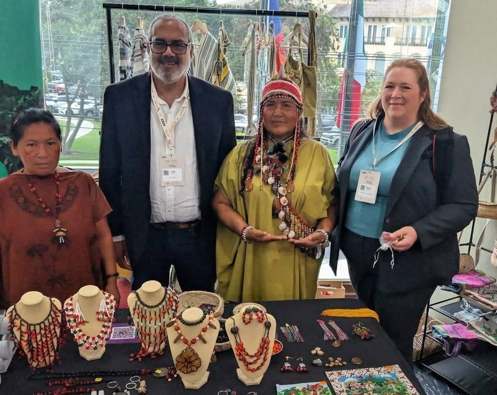 Dr. Andre West and Melissa Sharp at a booth displaying jewelry pieces.