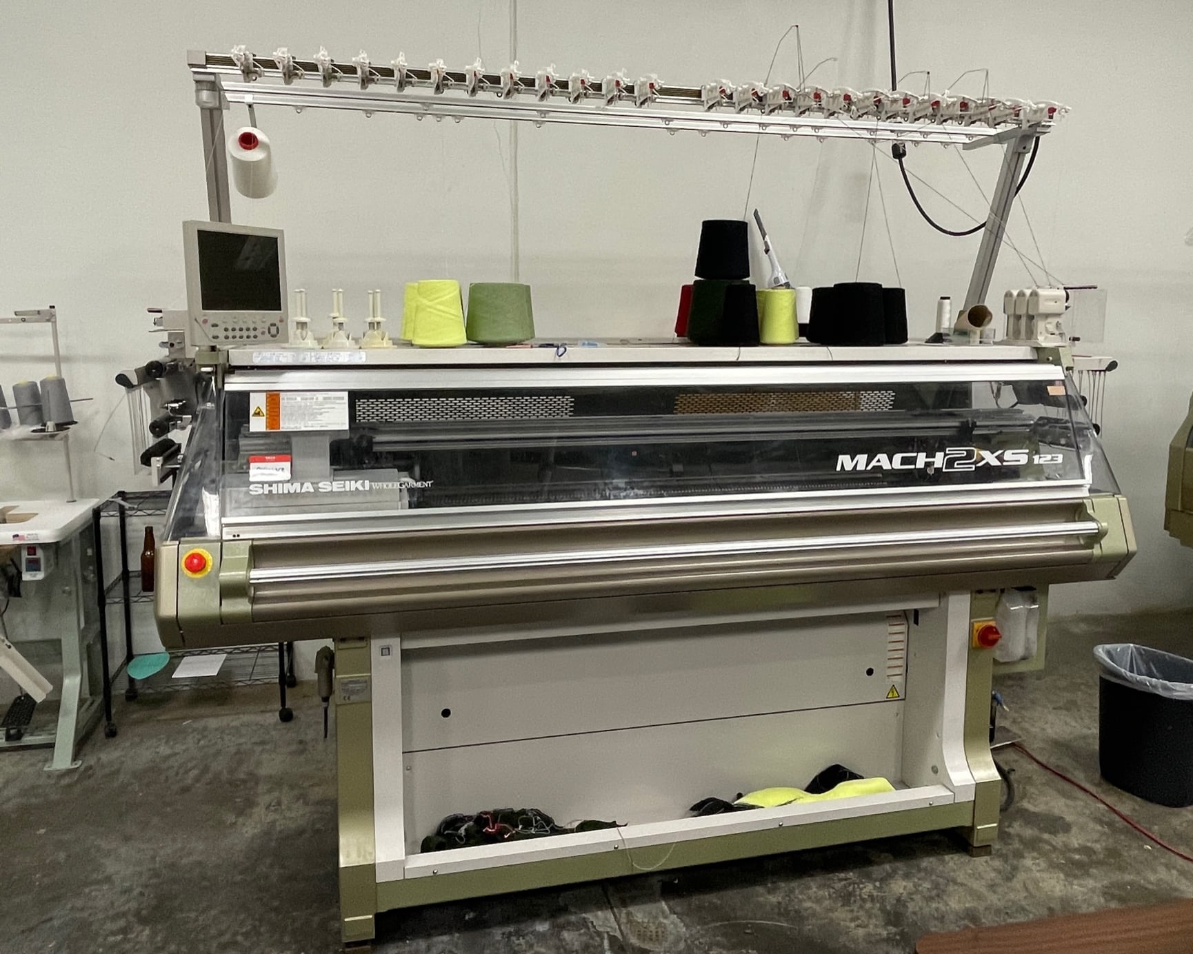 A Shima Seiki Mach2XS flat knitting machine with 8 and 15 gauge measuring