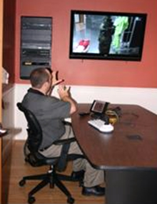 MIST protection performance displayed on a TV being assessed by a man sitting in a chair