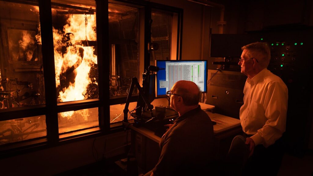 John Morton-Aslanis, research scholar and thermal lab manager, and Roger Barker, TPACC’s founder and director, run a test using the PyroMan, a life-size manikin used to evaluate the performance of thermal protective clothing, in the Milliken Textile Protection And Comfort Center on Centennial campus.
